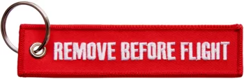 Varovné vlaječky tkané, s vyšitým nápisem "Remove Before Flight"